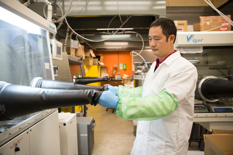 Man working with gloves in a clean environment