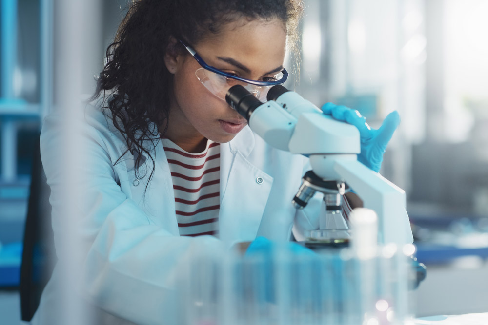 Student using lab equipment to analyze a sample