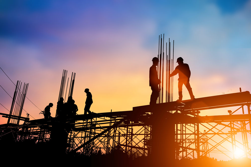 Construction workers standing on scaffolding